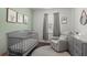 Bright Bedroom with a gray crib, comfortable glider chair, and stylish decor at 319 Knawl Rd, Moncks Corner, SC 29461