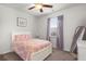 Well-lit bedroom with neutral walls, ceiling fan, window with blinds and decorative curtains at 319 Knawl Rd, Moncks Corner, SC 29461