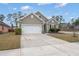 Charming single-Gathering home with a two-car garage, manicured lawn, and neutral colored siding at 319 Knawl Rd, Moncks Corner, SC 29461