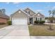 Charming single-Gathering home with a two-car garage, manicured lawn, and neutral colored siding at 319 Knawl Rd, Moncks Corner, SC 29461