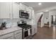 Open concept kitchen with stainless appliances, granite counters, gray cabinets, and a gas range at 319 Knawl Rd, Moncks Corner, SC 29461