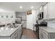 Open concept kitchen with stainless appliances, granite counters, gray cabinets, and a large island with seating at 319 Knawl Rd, Moncks Corner, SC 29461