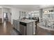 Open concept kitchen with stainless appliances, granite counters, gray cabinets, and view into living spaces at 319 Knawl Rd, Moncks Corner, SC 29461