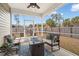 Cozy screened-in patio with comfortable seating and fire table, perfect for outdoor relaxation and enjoying the backyard at 319 Knawl Rd, Moncks Corner, SC 29461