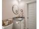 Well-lit bathroom featuring granite countertops, a stylish round mirror, and chic fixtures at 3563 Bayden Bridge Ln, Mount Pleasant, SC 29466