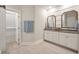 Bright bathroom with double vanity, granite countertops, framed mirrors, and tile flooring at 3563 Bayden Bridge Ln, Mount Pleasant, SC 29466