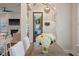 Open dining area with a rustic wood table, white-covered chairs, and view of the front entrance at 3563 Bayden Bridge Ln, Mount Pleasant, SC 29466