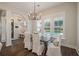 Dining room features a wooden table, covered chairs, and natural light streaming through shuttered windows at 3563 Bayden Bridge Ln, Mount Pleasant, SC 29466