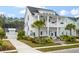 Charming two-story home with double porches, blue shutters, manicured lawn, and separate garage at 3563 Bayden Bridge Ln, Mount Pleasant, SC 29466