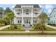 Charming two-story home with double porches, blue shutters, manicured lawn, and separate garage at 3563 Bayden Bridge Ln, Mount Pleasant, SC 29466