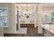 Sunlit foyer with a bench, storage baskets, and a view of the dining room at 3563 Bayden Bridge Ln, Mount Pleasant, SC 29466