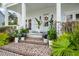 Close-up of a charming front porch with brick steps and beautifully arranged potted plants at 3563 Bayden Bridge Ln, Mount Pleasant, SC 29466
