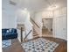 Hallway with stairs leading up to the second floor, view into a bedroom, and a blue couch at 3563 Bayden Bridge Ln, Mount Pleasant, SC 29466
