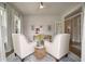 Inviting home office featuring two stylish white armchairs and a rustic wooden desk at 3563 Bayden Bridge Ln, Mount Pleasant, SC 29466