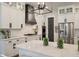Modern kitchen featuring a large island, white cabinets, black accents, and stainless steel appliances at 3563 Bayden Bridge Ln, Mount Pleasant, SC 29466