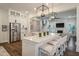 Spacious kitchen featuring white cabinetry, a large island with seating, and stainless steel appliances at 3563 Bayden Bridge Ln, Mount Pleasant, SC 29466