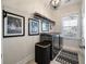 Well-organized laundry room with modern appliances, decorative accents, and ample storage space at 3563 Bayden Bridge Ln, Mount Pleasant, SC 29466