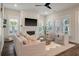 Bright living room with a fireplace, shiplap wall, and neutral-toned furniture arrangement at 3563 Bayden Bridge Ln, Mount Pleasant, SC 29466