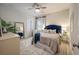 Stylish bedroom showcasing a plush bed, neutral color palette, ceiling fan, and soft natural light at 3563 Bayden Bridge Ln, Mount Pleasant, SC 29466