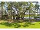 Lush green picnic area with two picnic tables surrounded by tall trees and glimpses of water at 3563 Bayden Bridge Ln, Mount Pleasant, SC 29466