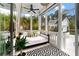 Screened porch with a stylish daybed, black and white rug, and view of the outdoors at 3563 Bayden Bridge Ln, Mount Pleasant, SC 29466