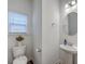 Cozy half bathroom with a pedestal sink, toilet, and a small window at 428 Avocet Dr, Summerville, SC 29486