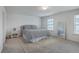 Inviting bedroom showcasing a plush bed, soft rug, bright window, and neutral wall decor at 428 Avocet Dr, Summerville, SC 29486