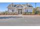Charming, light-gray clubhouse with a gated entry, complemented by neat landscaping and ample parking space at 428 Avocet Dr, Summerville, SC 29486
