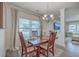 Cozy dining area with a chandelier, wood table set and backyard views at 428 Avocet Dr, Summerville, SC 29486