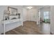 Bright foyer with wood flooring, stylish console table, and view into adjacent room at 428 Avocet Dr, Summerville, SC 29486