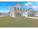 Inviting two-story home with cozy front porch seating and an attached garage at 428 Avocet Dr, Summerville, SC 29486
