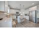 Modern kitchen with stainless steel appliances, white cabinets, quartz countertops, and a center island with bar stools at 428 Avocet Dr, Summerville, SC 29486