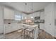 Bright kitchen featuring white cabinets, an island with barstool seating, and modern pendant lighting at 428 Avocet Dr, Summerville, SC 29486