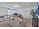 Cozy living room with beige sofa, desk, TV, and ample natural light through the window at 428 Avocet Dr, Summerville, SC 29486