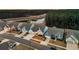 Drone view of light blue homes with an attached garage, a nearby pond, and surrounded by forest at 455 Hidden Meadow Ln, Summerville, SC 29486