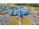 Aerial view of community clubhouse and pool area featuring tennis courts and manicured landscaping at 455 Hidden Meadow Ln, Summerville, SC 29486