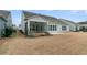 Backyard with a screened porch, concrete patio, and lush landscaping for relaxation at 455 Hidden Meadow Ln, Summerville, SC 29486