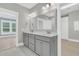 Bathroom features a double vanity with gray cabinets, white countertops and gray tile floors at 455 Hidden Meadow Ln, Summerville, SC 29486