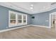 Bedroom features hardwood floors, blue walls, plantation shutters, and tray ceiling at 455 Hidden Meadow Ln, Summerville, SC 29486