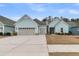 Charming one-story home with light blue siding, a grey roof, an attached garage, and a concrete driveway at 455 Hidden Meadow Ln, Summerville, SC 29486