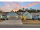 Charming one-story home with light blue siding and a grey roof, set against a colorful sky at 455 Hidden Meadow Ln, Summerville, SC 29486