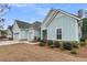 Charming one-story home with light blue siding, grey roof, an attached garage and landscaped garden at 455 Hidden Meadow Ln, Summerville, SC 29486