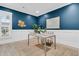 Comfortable home office with natural light, bright blue wall, modern decor, and white wainscoting at 455 Hidden Meadow Ln, Summerville, SC 29486