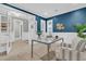 Stylish home office featuring a gray table, bright blue accent wall, and a comfortable striped chair at 455 Hidden Meadow Ln, Summerville, SC 29486