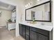 Bathroom with double sinks, a large mirror, and connection to the bedroom, offering convenience and style at 482 Rowley Ln, Summerville, SC 29486