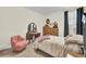 A bedroom with antique vanity and pink chair is traditionally furnished with plenty of light and closet space at 482 Rowley Ln, Summerville, SC 29486