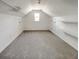 Finished attic space with built in storage, neutral carpet, and a dormer window at 503 Middleton Blvd, Summerville, SC 29485