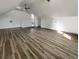 Bright attic space features hardwood floors, a ceiling fan, and a small window for natural light at 503 Middleton Blvd, Summerville, SC 29485