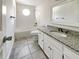 Bathroom with granite counters, framed mirror and combined tub and shower at 503 Middleton Blvd, Summerville, SC 29485