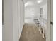 Second floor hallway with neutral carpet, white railing and closet at 503 Middleton Blvd, Summerville, SC 29485